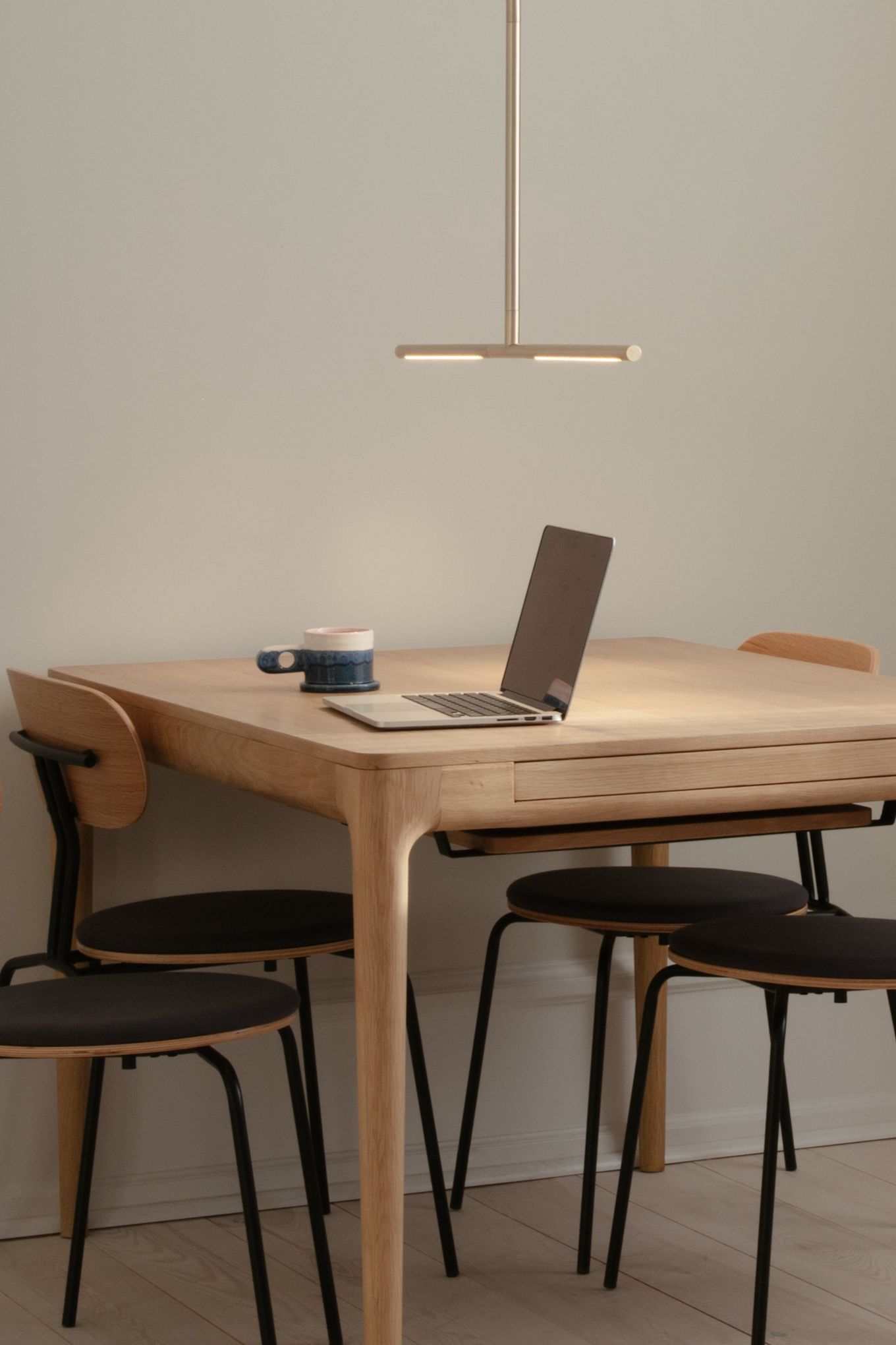 Here you see the Omni ceiling lamp hanging over a desk with a laptop. Over head lighting is an essential part of any home office to illuminate the space. 